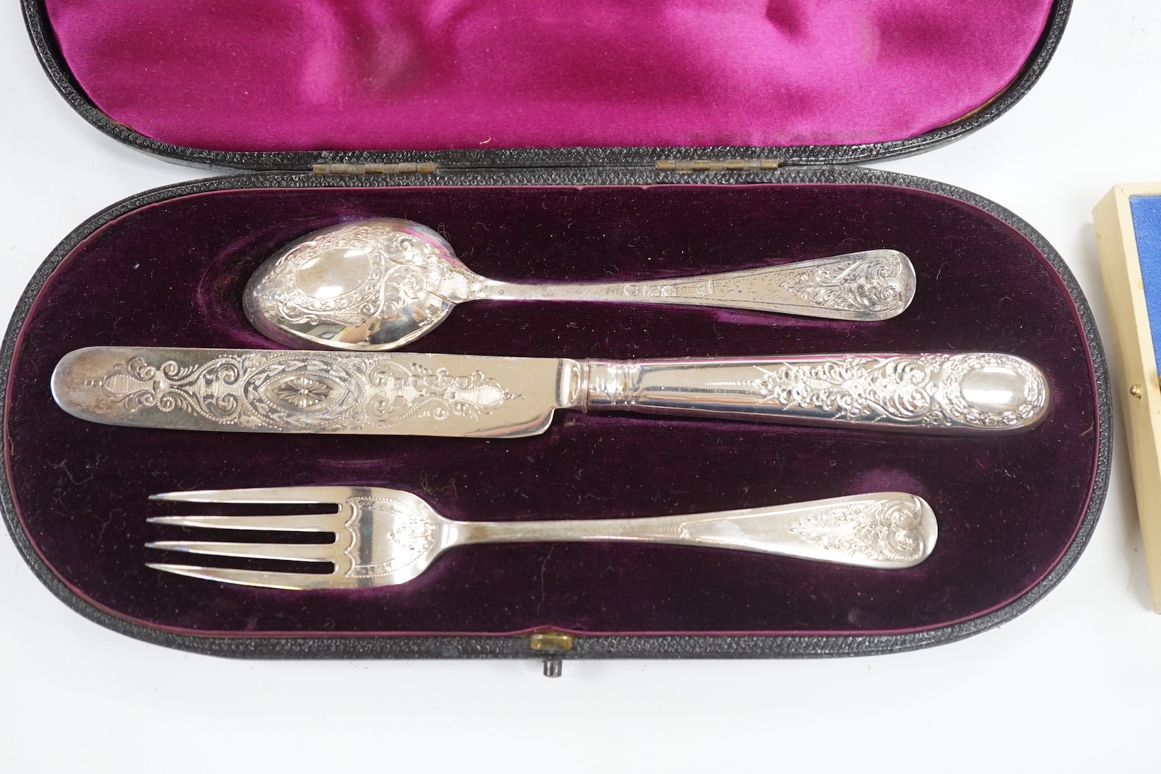 A late Victorian cased chased silver christening trio, London, 1897/90, together with a pair of engraved 925 cufflinks. Condition - fair